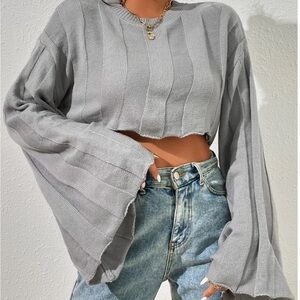 gray cropped sweater with bell sleeves.
